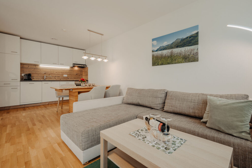 Blick von hellem modernen Sofa auf Essbereich und Küche